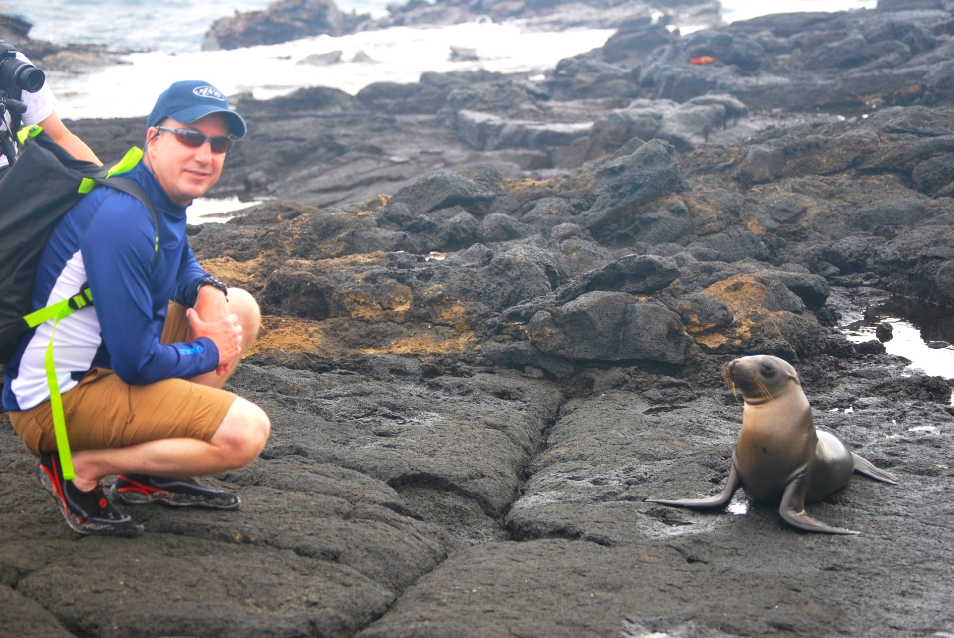 Greg Woods beside a sea lion on the Galápagos Islands